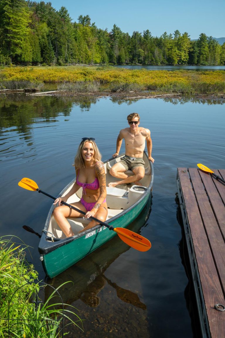 Two people in a canoe on a lake.