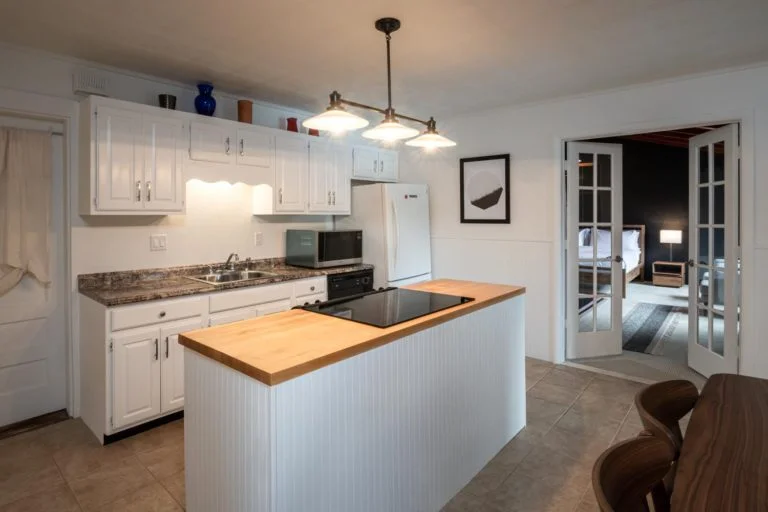 A kitchen with a stove and refrigerator.