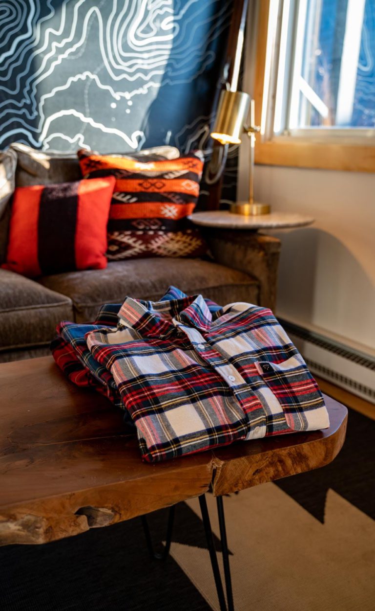 A plaid shirt is sitting on a table in a living room.