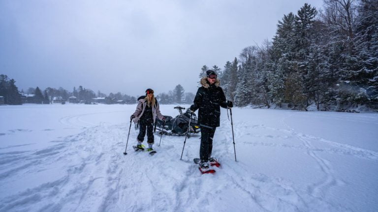 Two people on snow skis on a frozen lake.