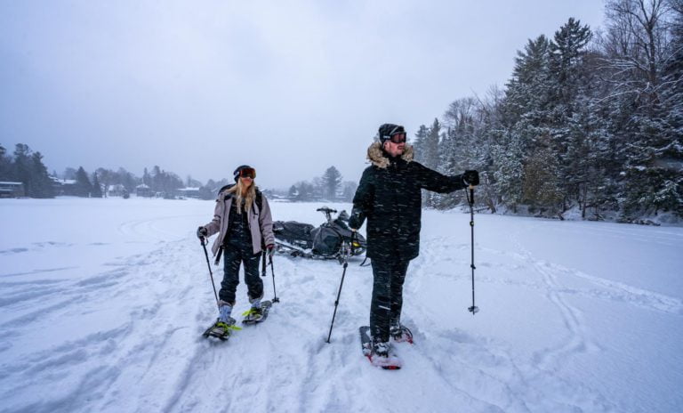Two people standing in the snow on skis.